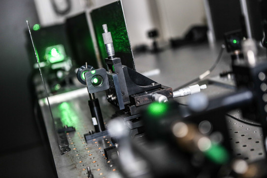 A detail shot of a laser in the lab in green colors.