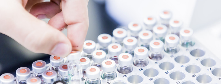 Several sample vessels in a container in the laboratory.